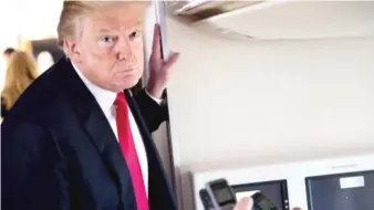  ?? SAUL LOEB/ AFP/ GETTY IMAGES ?? President Donald Trump speaks to the press Friday aboard Air Force One.