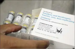  ?? San Francisco Chronicle file photo via AP ?? Pharmacist Jonathan Parducho removes a tray of vials of of the Jynneos vaccine for monkeypox from a box containing 20 doses, in the vaccine hub at Zuckerberg San Francisco General Hospital on July 29 in San Francisco.