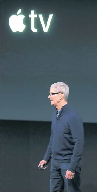  ??  ?? Apple chief Tim Cook talks about Apple TV at headquarte­rs in Cupertino, California. The tech giant is testing the latest iteration of the product, which has seen declining sales.