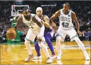  ?? Winslow Townson / Associated Press ?? The Celtics’ Kyrie Irving, left, holds off the 76ers’ Jerryd Bayless during the third quarter Thursday in Boston.