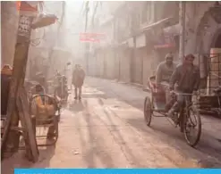  ??  ?? NEW DELHI: An Indian bicycle rickshaw driver pedals down an alleyway on a foggy morning in New Delhi yesterday. —AFP