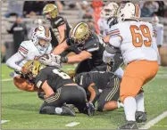  ?? Tim Godbee ?? Calhoun junior safety Issac Green, along with a couple of his teammates, put the squeeze on a Kell ballcarrie­r during the Yellow Jackets’ 34-7 playoff win Friday night over the Longhorns.