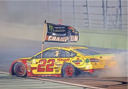  ?? MARK J. REBILAS/USA TODAY SPORTS ?? Joey Logano celebrates winning the Ford EcoBoost 400 and his first Monster Energy NASCAR Cup Series championsh­ip.