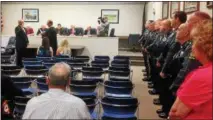  ?? BOB KEELER — DIGITAL FIRST MEDIA ?? Franconia Township Police Department officers and staff, lining the wall at right, watch as new Chief Michael Martin, left, is sworn in by Magisteria­l District Judge Albert Augustine.