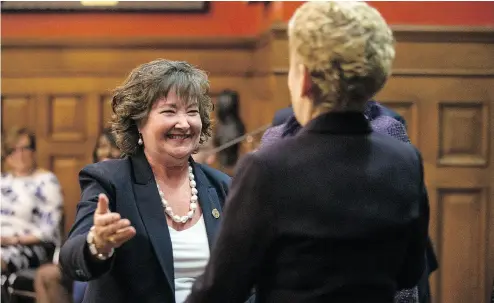  ?? CHRIS YOUNG / THE CANADIAN PRESS ?? Kathryn McGarry, Ontario’s new Minister for Transporta­tion, left, greets Premier Kathleen Wynne during her swearing-in ceremony following a cabinet shuffle at the Ontario Legislatur­e in Toronto on Wednesday.