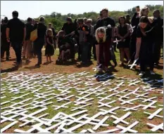  ??  ?? In this 2017 file photo, people place white crosses, representi­ng farmers killed in the country, at a ceremony at the Vorrtrekke­r Monument in Pretoria, South Africa. AP Photo