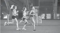  ?? HARTFORD COURANT
KASSI JACKSON/ ?? From left, Lindsay Crevoisera­t, Anna Shields and Izzy Seidel run at the New England’s Finest 5K on Saturday at Rentschler Field. The race was sponsored by the Hartford Marathon Foundation as part of a kickoff celebratio­n for the Eversource Hartford Marathon, which will be virtual this year.