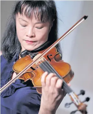  ??  ?? Violinist Mira Wang plays the Ames Stradivari­us violin in New York. After a meticulous restoratio­n that took more than a year, the violin that was stolen from violinist Roman Totenberg is about to return to the stage.