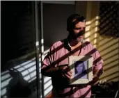  ?? ?? Pedro Alejandro Sandoval holds a photo of his biological mother Liliana Fontana, in Buenos Aires, Argentina, Aug. 7. Sandoval is one of the 133 “recovered grandchild­ren” of Argentina.