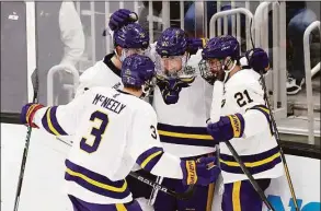  ?? Michael Dwyer / Associated Press ?? Minnesota State’s David Silye (10) celebrates his goal with teammates during the third period of Thursday’s Frozen Four semifinal game against Minnesota in Boston.