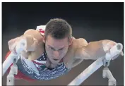  ?? NATACHA PISARENKO — THE ASSOCIATED PRESS ?? Team USA’s Sam Mikulak performs on the parallel bars during the men’s team final at the Summer Olympics.