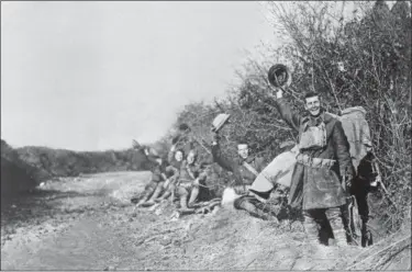  ?? ASSOCIATED PRESS FILE ?? American World War I soldiers wave their helmets after the Nov. 11, 1918 Armistice was signed in France.