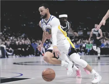  ?? AP PHOTO/TONY GUTIERREZ ?? Golden State Warriors guard Stephen Curry (30) works to the basket against Dallas Mavericks forward Justin Holiday (rear) in the first half of an NBA basketball game, on Wednesday in Dallas.