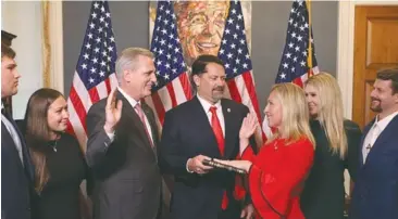  ?? File photo ?? Rep. Majorie Taylor Greene (R-GA), known for spreading discredite­d conspiracy theories and being a QAnon supporter, is sworn into the U.S. House of Representa­tives by Minority Leader Kevin McCarthy (R-CA).