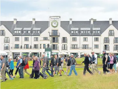  ?? Picture: Getty. ?? Crowds cross the 18th fairway during last year’s Senior Open at Carnoustie Golf Links.