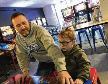  ?? CONTRIBUTE­D ?? Jim Foliano (left) practices at the Pinball Garage in Hamilton. Foliano is playing pinball on an Avengers: Infinity Quest Pinball Machine – the machine he will play in a bid to break a world record.