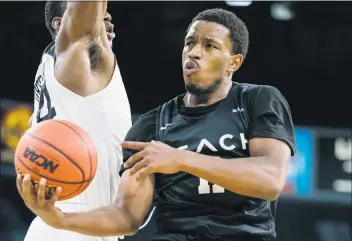  ?? PHOTO COURTESY OF BIG WEST CONFERENCE ?? Long Beach State’s Isaiah Washington dishes the ball around a Cal State Northridge defender during their Big West Tournament first-round game Tuesday at Mandalay Bay in Las Vegas. Long Beach State won, 85-63.