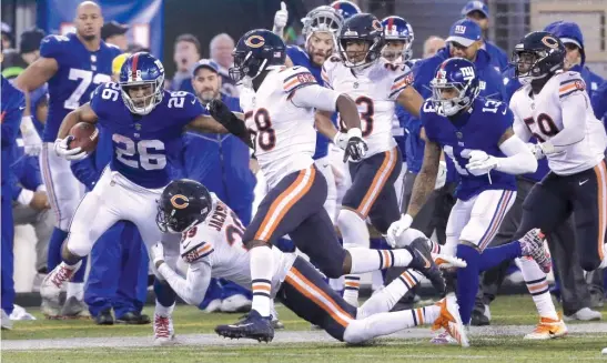  ?? SETH WENIG/AP ?? The Bears’ defense had a difficult time against Giants rookie running back Saquon Barkley last Sunday in East Rutherford, N.J. Barkley rushed for 125 yards.