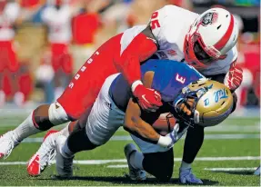  ?? JESSIE WARDARSKI/TULSA WORLD VIA AP ?? New Mexico’s Garret Hughes tackles Tulsa running back Shamari Brooks during the Lobos’ 16-13 win last week in Tulsa, Okla. The Lobos currently rank 17th in the FBS in team rushing defense, giving up just 97 yards per game.