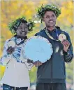  ?? SETH WENIG THE ASSOCIATED PRESS ?? First-place finishers Mary Keitany of Kenya and Lelisa Desisa of Ethiopia pose for a picture at the finish line of the New York City Marathon on Sunday.