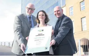  ??  ?? Achievemen­t Council leader John Ross, food policy officer Helene Gourichon and chief executive Cleland Sneddon celebrate South Lanarkshir­e’s renewed Fairtrade status