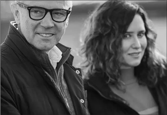  ?? MANU FERNANDEZ / ASSOCIATED PRESS ?? Stefano Domenicali, CEO of Formula One Group, left, and Isabel Diaz Ayuso, president of the Madrid Regional Government, are seen prior to a news conference Tuesday announcing Madrid’s return to the F1 circuit beginning in 2026.