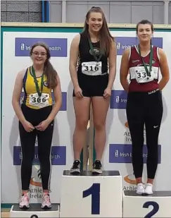  ??  ?? Liene Kaugare tops the podium for the Under-17 shot putt.