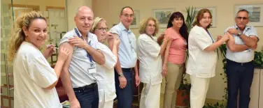  ?? (Text: Judy Siegel; photo: Poriya Medical Center) ?? Poriya Medical Center’s top staff roll up their sleeves to receive their flu shots yesterday at the Tiberias hospital.