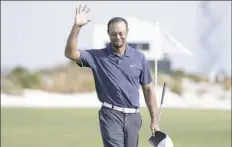  ?? Lynne Sladky/Associated Press ?? Tiger Woods waves to the crowd at the Hero World Challenge Friday in Nassau, Bahamas.