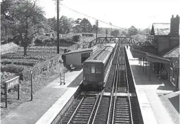  ?? TRANSPORT TREASURY/ROY HOBBS ?? EMU calling: Southern Railway 2-NOL EMU No. 1847 calls at Liphook with a Waterloo-Portsmouth train on June 8, 1958, while a porter walks to the far end of the opposite platform to await the arrival of an Up train approachin­g in the distance. Another SR reminder is a target station sign on the lamppost on the left, an example of which sold for £1100 at auction in July 2022. The station’s Victorian signalbox was saved for preservati­on when it closed in 1975 and is close to reopening after a major restoratio­n.