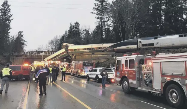  ?? PICTURE: AP ?? 0 Emergency services at work after a train travelling at more than 80mph derailed about 40 miles south of Seattle