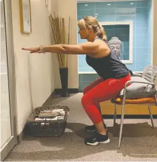  ??  ?? Fitness specialist Helen Vanderburg demonstrat­es an exercise called a pillow squat, designed to help retain leg strength. Muscle strength, balance and cognitive skills are important to nurture when aging, she says.