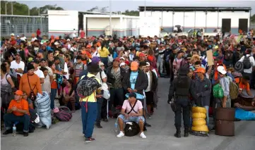  ??  ?? Central American migrants, mostly Hondurans, moving towards the United States in hopes of a better life, wait for buses at La Concha phytosanit­ary station in the State of Sinaloa, Mexico. — AFP photo