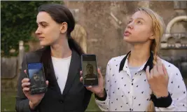  ?? ALESSANDRA TARANTINO — THE ASSOCIATED PRESS ?? Kateryna Prokopenko, right, wife of Denys Prokopenko, commander of the Azov Regiment, and Yulia Fedusiuk, wife of Arseny Fedosiuk, another member of Azov regiment, get emotional as they show photos of their husbands on their phones in Rome on Friday.