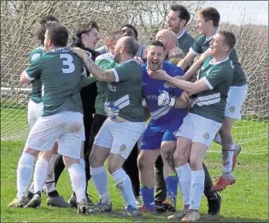  ?? Picture: Tracey Corps ?? Ashford United 3rds congratula­te goalkeeper Gregg Moncrieff, who saved two penalties in the semi-final shoot-out win against Singleton Barn