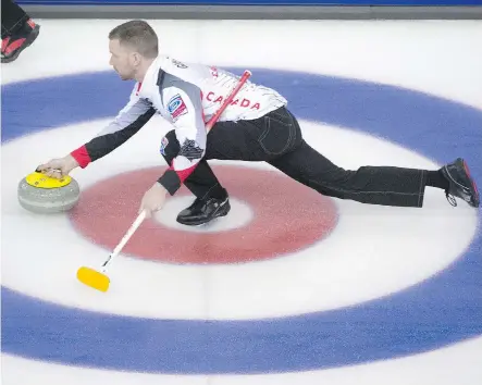  ?? JONATHAN HAYWARD /THE CANADIAN PRESS ?? Team Canada skip Brad Gushue makes a shot for a draw against Russia at the world men’s curling championsh­ip in Edmonton on Sunday morning. Gushue’s rink, which features Tom Sallows as fifth, beat Russia 11-3 and finished the day at 3-0.