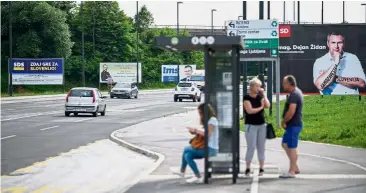  ?? — AFP ?? Ready to battle it out: Cars passing by electoral billboards in Ljubljana ahead of the general election.