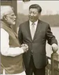  ?? AFP ?? Prime Minister Narendra Modi ) and Xi Jinping at Wuhan