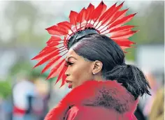  ?? ?? On the money: a racegoer suitably adorned for Ladies Day at the Cheltenham Festival