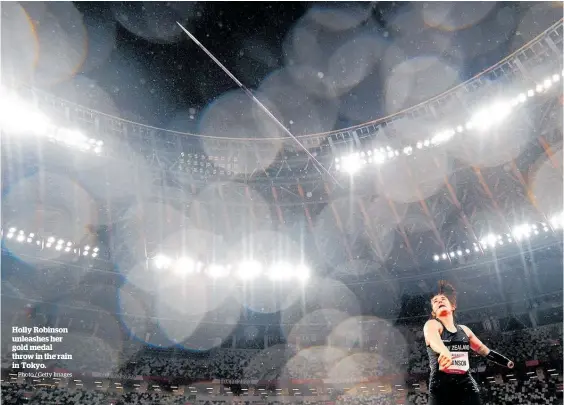  ?? Photo / Getty Images ?? Holly Robinson unleashes her gold medal throw in the rain in Tokyo.