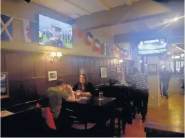  ??  ?? Inside the refurbishe­d Rummer Tavern in Cardiff, which now shows sports on a large screen and hosts a pool table.