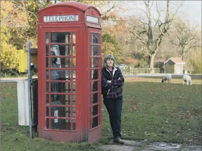  ?? PICTURE: JONATHAN GAWTHORPE ?? LIFELINE: Parish councillor Jayne Harker with the working red phone box on Goathland village green.