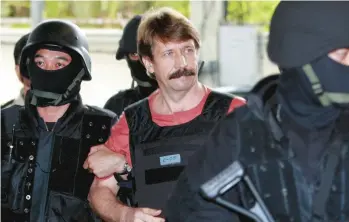  ?? APICHART WEERAWONG/AP ?? Russian arms dealer Viktor Bout is led by Thai police into criminal court in Bangkok in 2010 prior to his extraditio­n to the U.S. Now Bout is back in the headlines with speculatio­n about being part of a U.S.-Russia prisoner exchange.