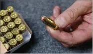  ?? BY RICH PEDRONCELL­I AP FILE PHOTO ?? In this photo taken June 11, Chris Puehse, owner of Foothill Ammo displays a .45 caliber bullet for sell at his store in Shingle Springs, Calif. California­ns will have to undergo criminal background checks every time they buy ammunition starting July 1 under a 2016 voter-approved ballot initiative.