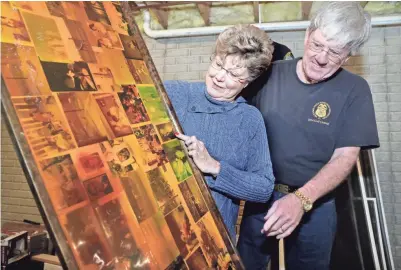  ??  ?? Joe and Vicki Hoeller enjoy their old memories at their Oak Creek home after the new owners of a home they sold in 2002 agreed to let the family take back the bar top that held the laminated photos.