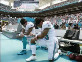  ?? WILFREDO LEE — THE ASSOCIATED PRESS ?? Miami Dolphins wide receiver Kenny Stills (10) and Miami Dolphins wide receiver Albert Wilson (15) kneel during the national anthem before an NFL football game against the Tennessee Titans, Sunday in Miami Gardens, Fla.