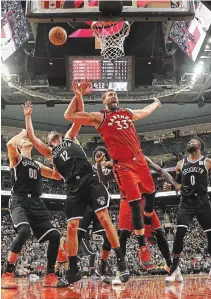  ?? STEVE RUSSELL TORONTO STAR FILE PHOTO ?? Raptors centre Marc Gasol is fouled by Brooklyn Nets guard Joe Harris (12) in Toronto on Dec. 14. Gasol has been out for 12 games after injuring his left hamstring in Detroit on Dec. 18.