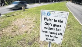  ?? Brian van der Brug
Los Angeles Times ?? A SIGN on Sunset Boulevard in Beverly Hills. The city turned off sprinklers because of the drought, and recent rains have helped turn medians green again.