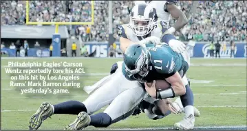  ?? GETTY IMAGES ?? Philadelph­ia Eagles’ Carson Wentz reportedly tore his ACL on this hit by Los Angeles Rams’ Mark Barron during yesterday’s game.