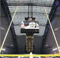  ?? DONNA MCWILLIAM/ THE ASSOCIATED PRESS FILES ?? The latest technology in the NFL will be putting computer chips into footballs to help determine if the uprights needed to be narrower.